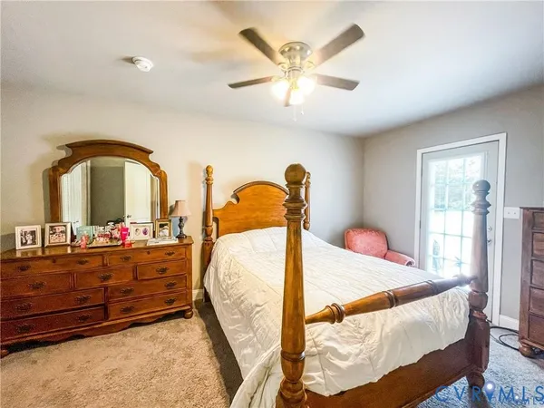 a en suite bathroom with a granite countertop sink and a mirror