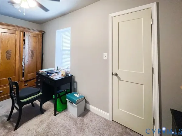 a view of a livingroom with a ceiling fan and window