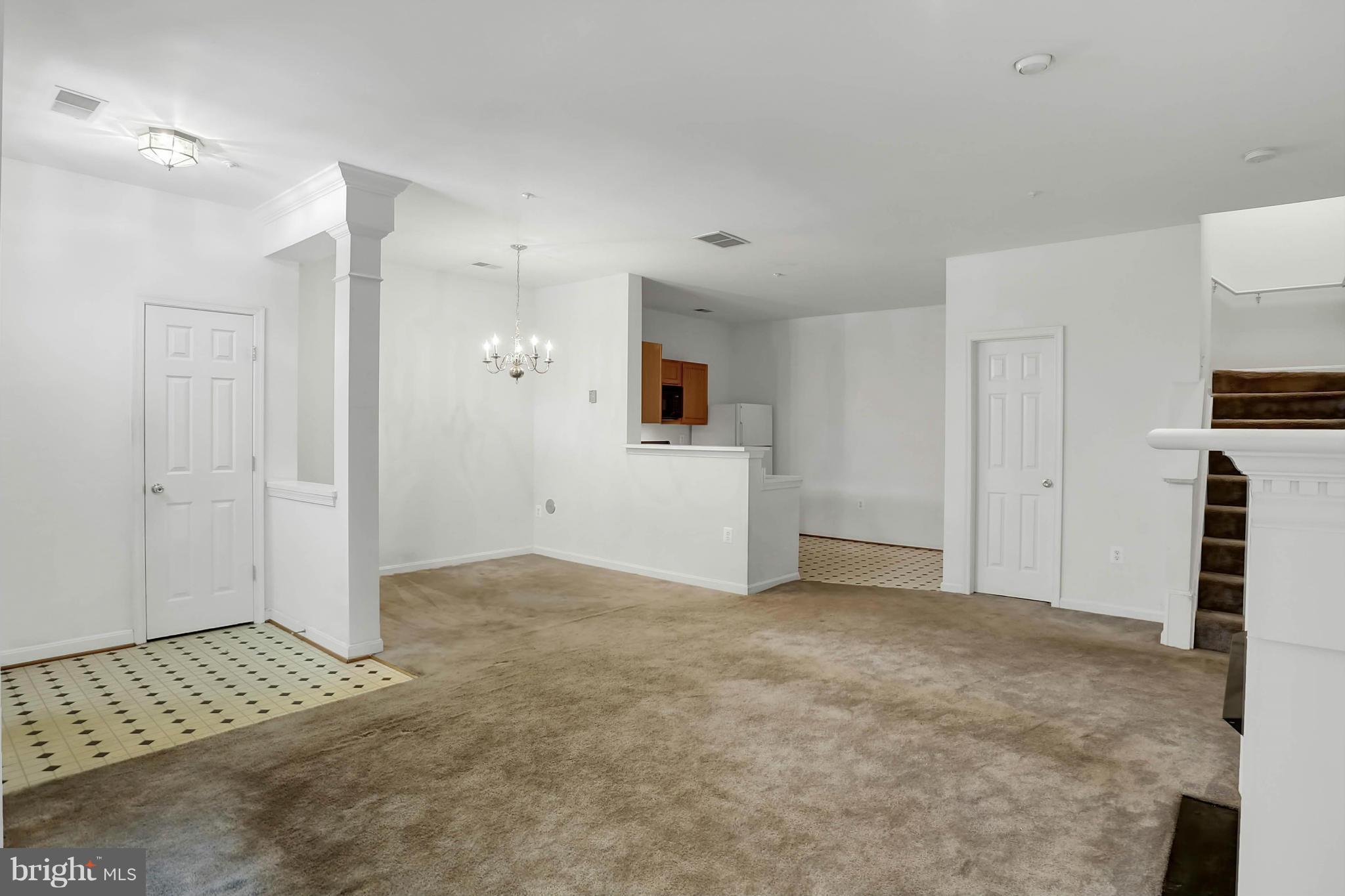 8724 Autumn Ridge Court Odenton, MD 21113 - Photo 3 of 24 a view of an empty room with kitchen and a window