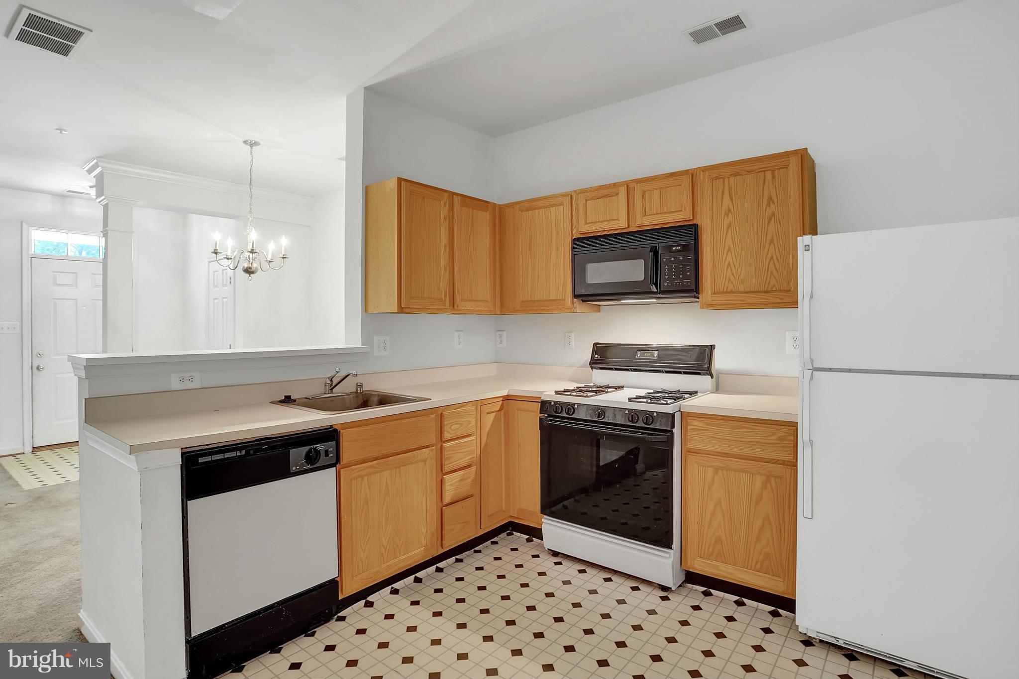 8724 Autumn Ridge Court Odenton, MD 21113 - Photo 5 of 24 a kitchen with stainless steel appliances a stove a sink and a refrigerator