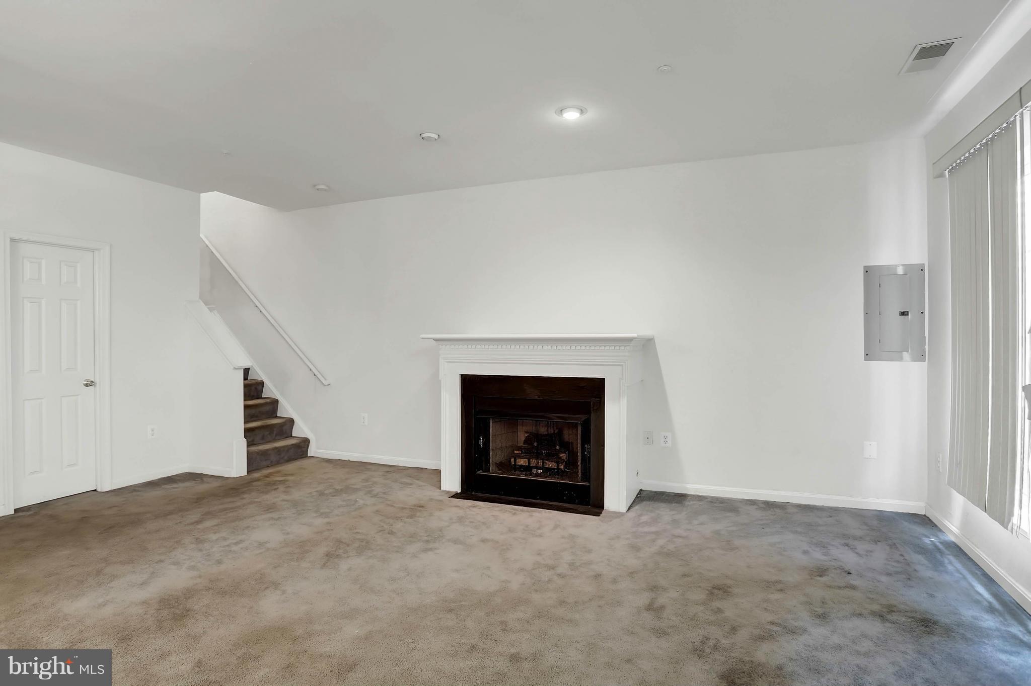 8724 Autumn Ridge Court Odenton, MD 21113 - Photo 8 of 24 a view of an empty room with fire place and a fireplace