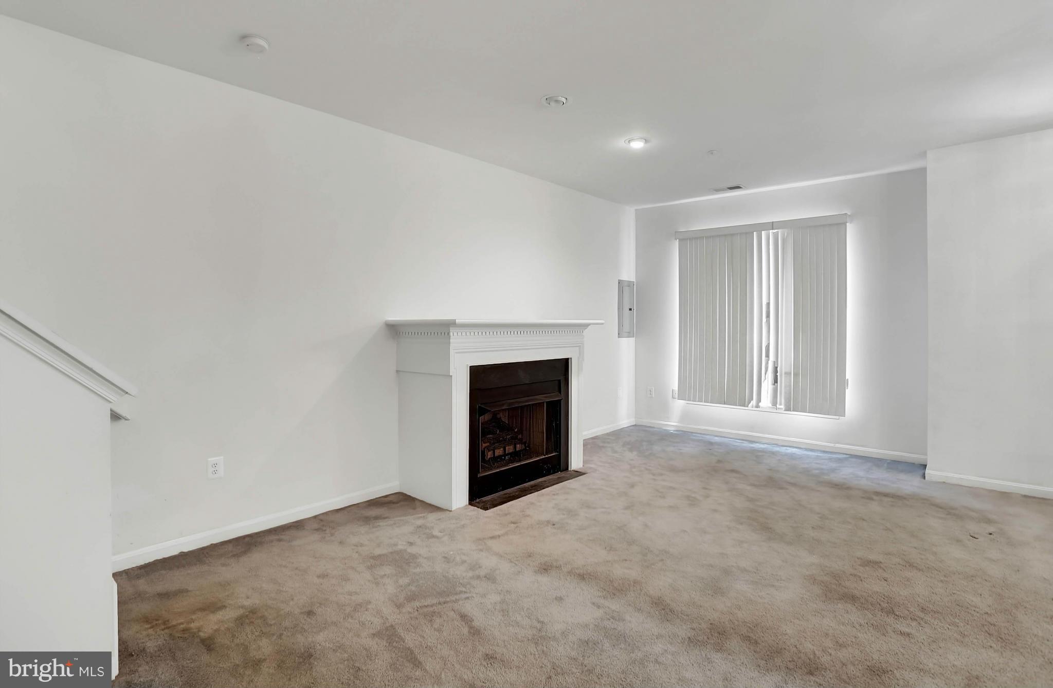 8724 Autumn Ridge Court Odenton, MD 21113 - Photo 9 of 24 a view of a livingroom with a fireplace and a window
