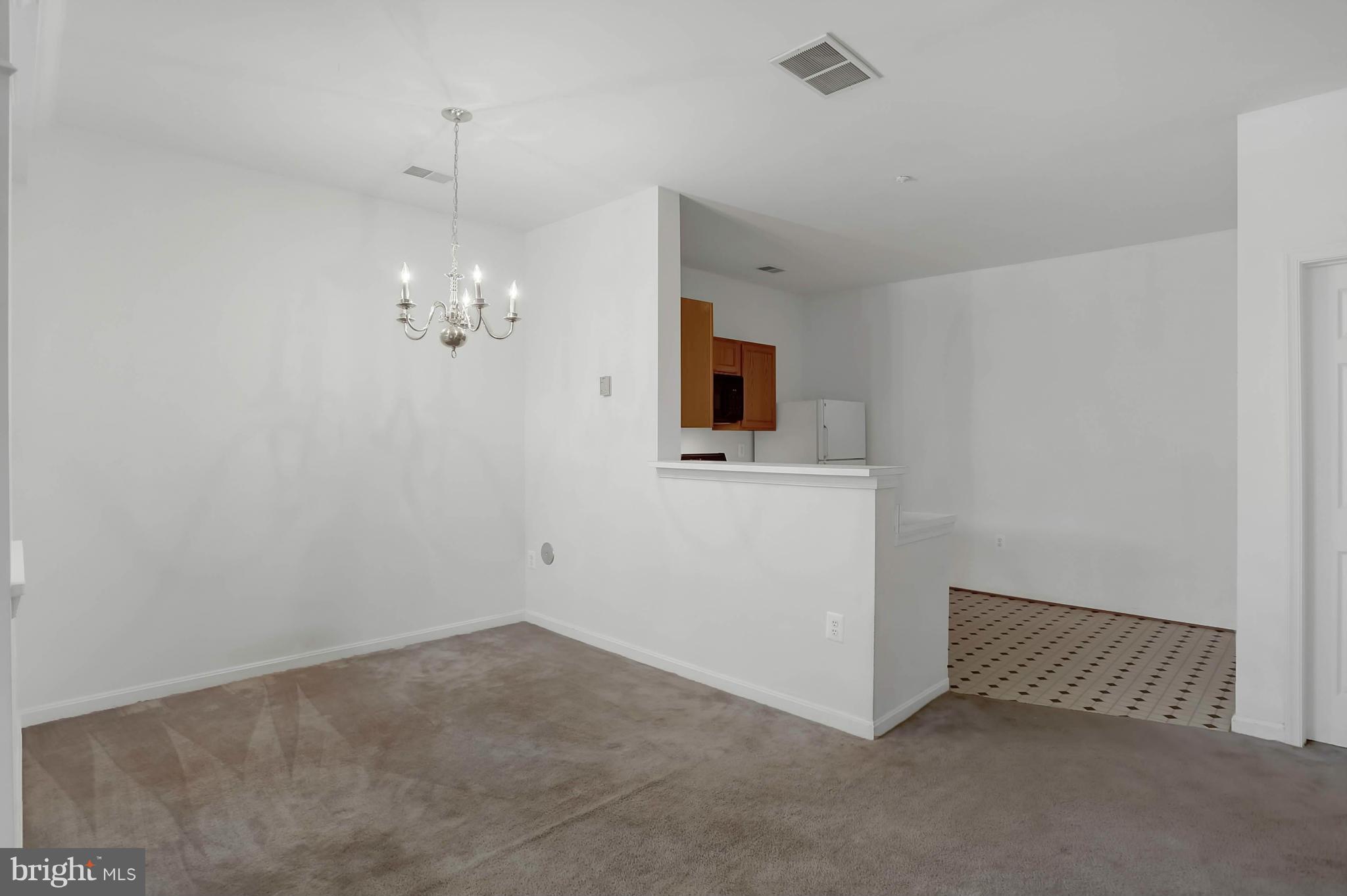 8724 Autumn Ridge Court Odenton, MD 21113 - Photo 10 of 24 a view of a hallway with a chandelier