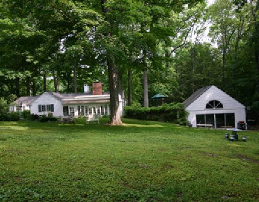 147 Grumman Hill Road Wilton, CT 06897 - Photo 1 of 1 a front view of a house with a garden