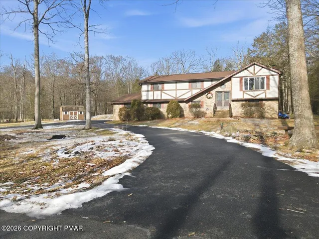 a view of a large house with a yard covered with snow