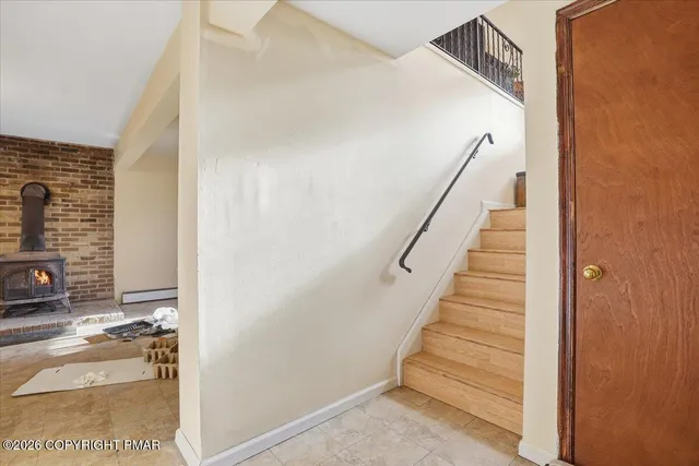 a roof deck with table and chairs and potted plants