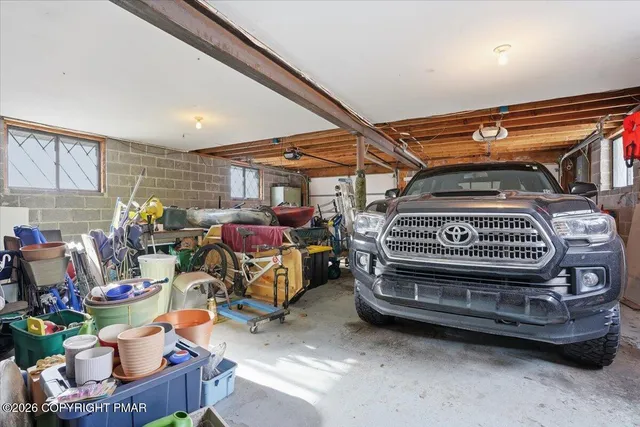 a view of a house with a yard covered in snow