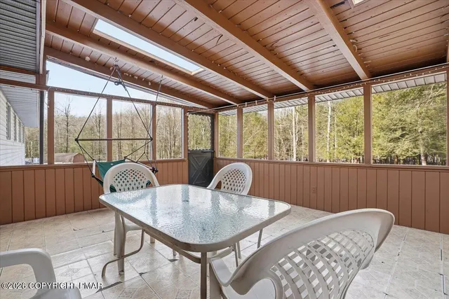 a view of a house with a yard covered in snow