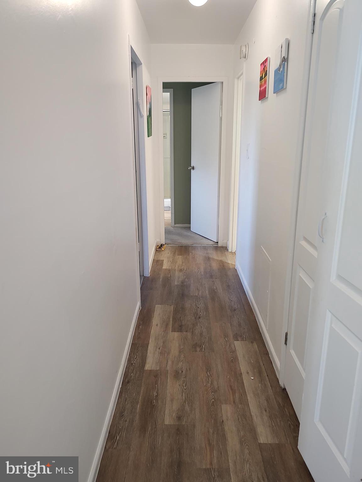 1111 University Boulevard West, Unit 719A Silver Spring, MD 20902 - Photo 12 of 41 a view of a hallway with wooden floor