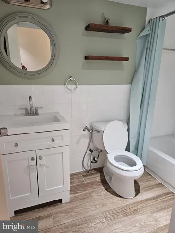 a bathroom with a toilet a sink and a mirror