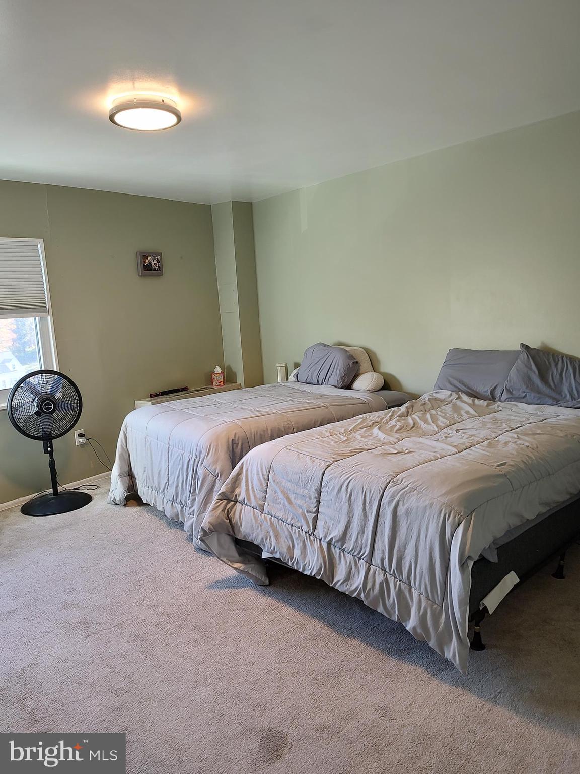 1111 University Boulevard West, Unit 719A Silver Spring, MD 20902 - Photo 15 of 41 a bedroom with two beds and painting on the wall