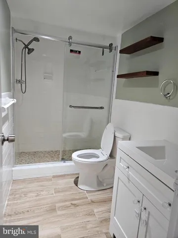 a bathroom with a toilet and a shower