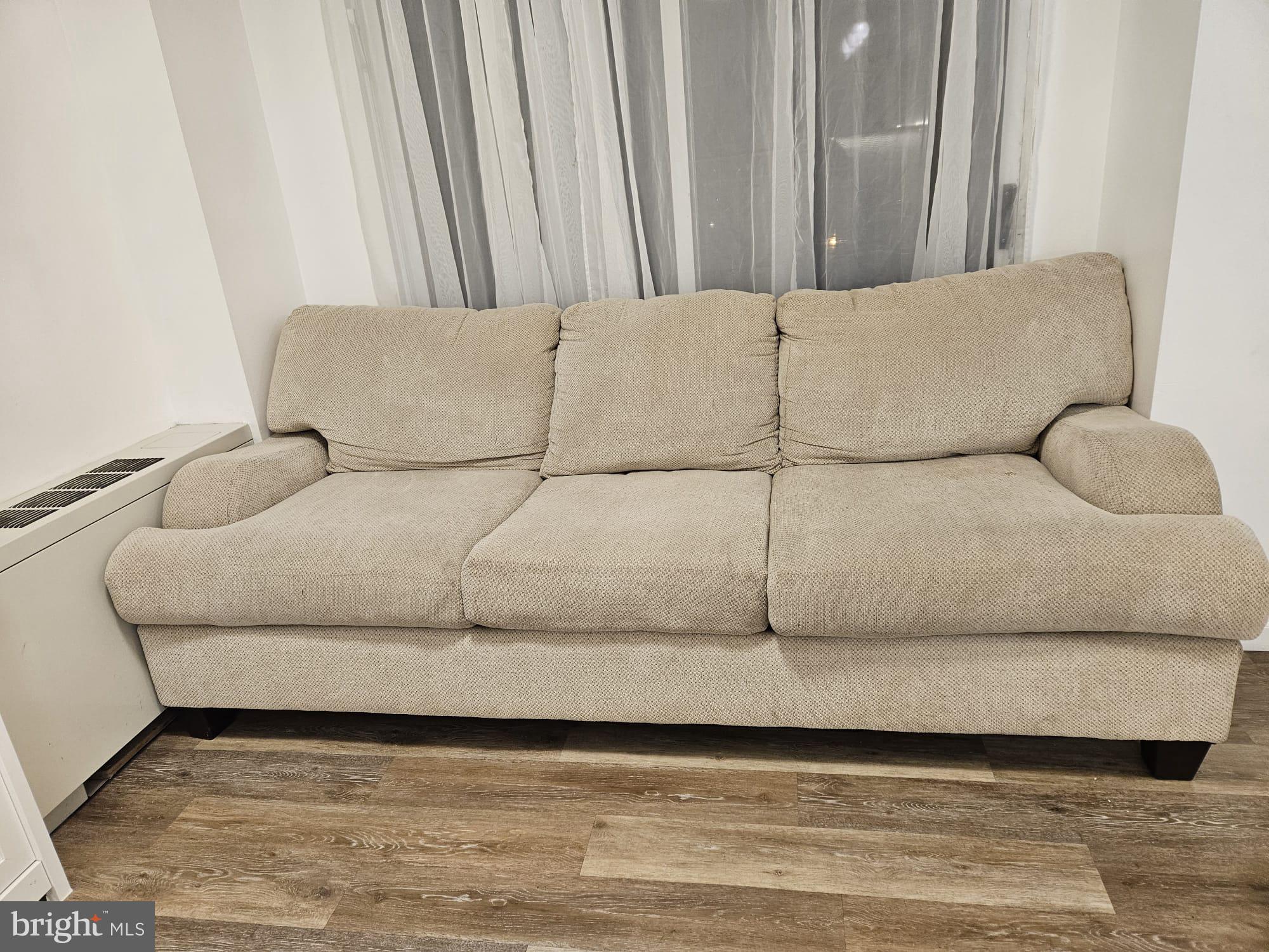 1111 University Boulevard West, Unit 719A Silver Spring, MD 20902 - Photo 2 of 41 a living room with a couch and a rug