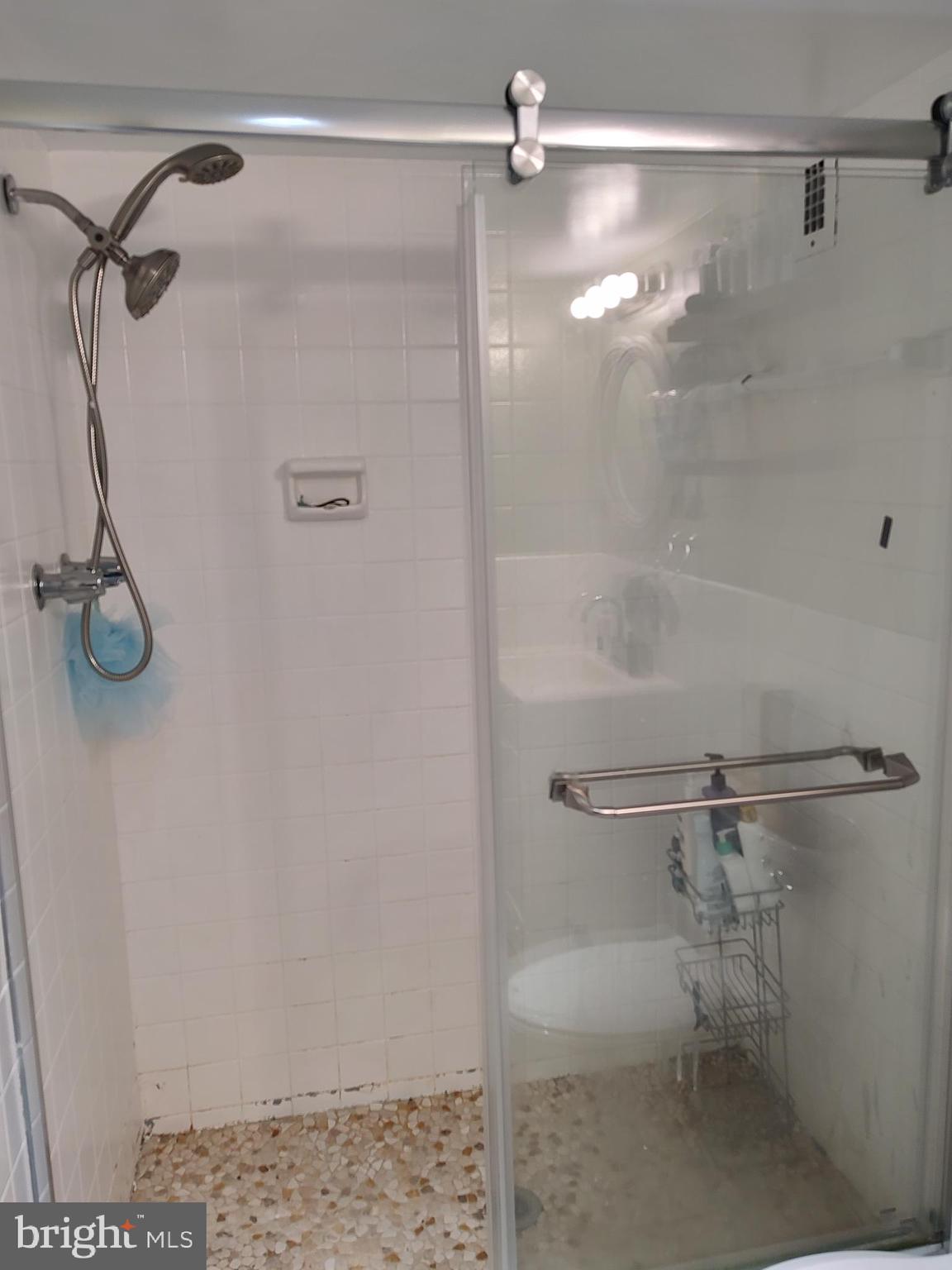 1111 University Boulevard West, Unit 719A Silver Spring, MD 20902 - Photo 21 of 41 a bathroom with a shower