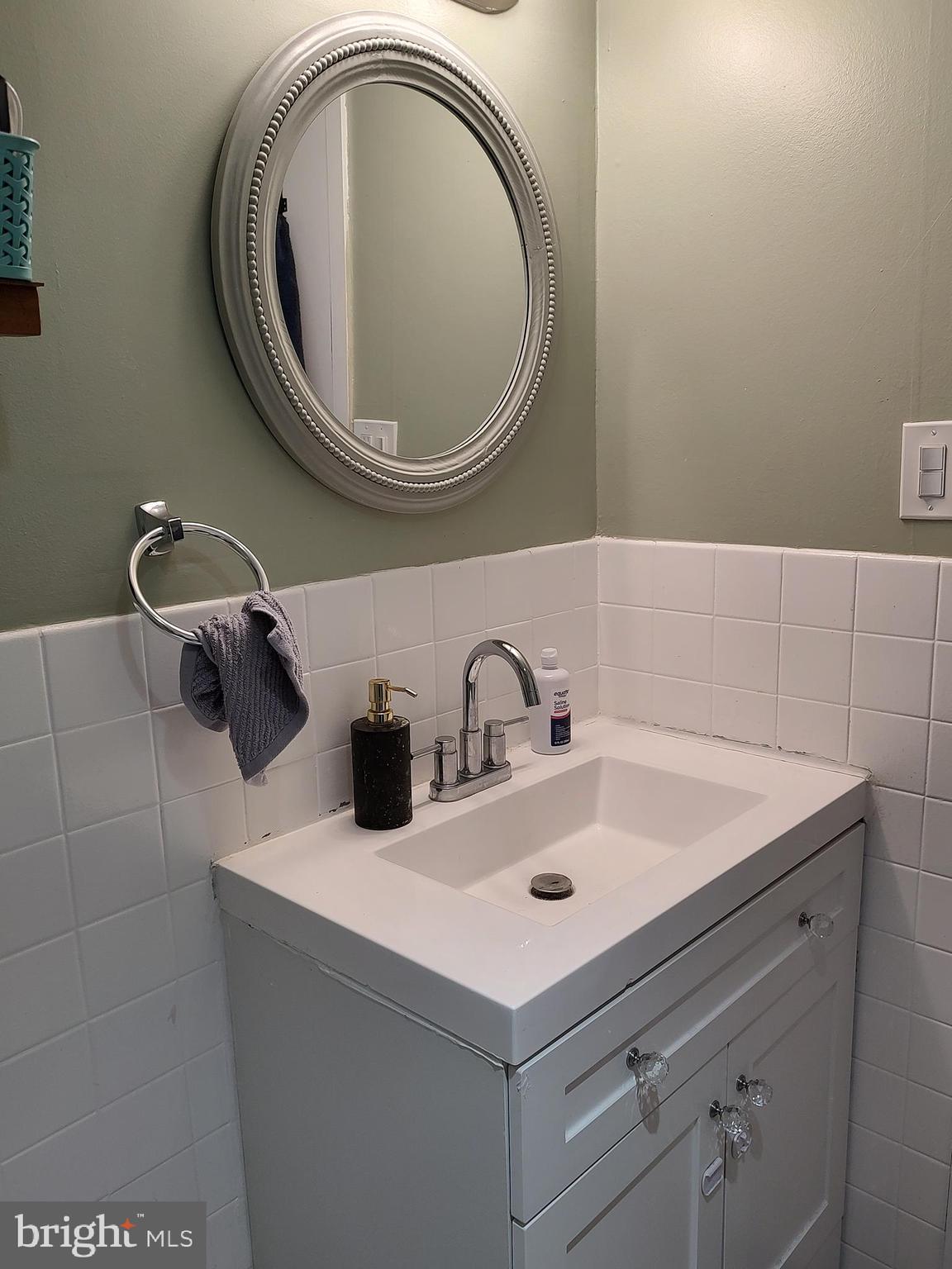 1111 University Boulevard West, Unit 719A Silver Spring, MD 20902 - Photo 22 of 41 a bathroom with a sink and a mirror