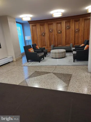 a living room with furniture a rug and a window