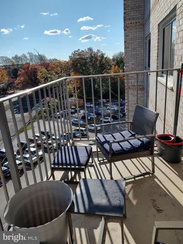a view of a chairs and table in the balcony