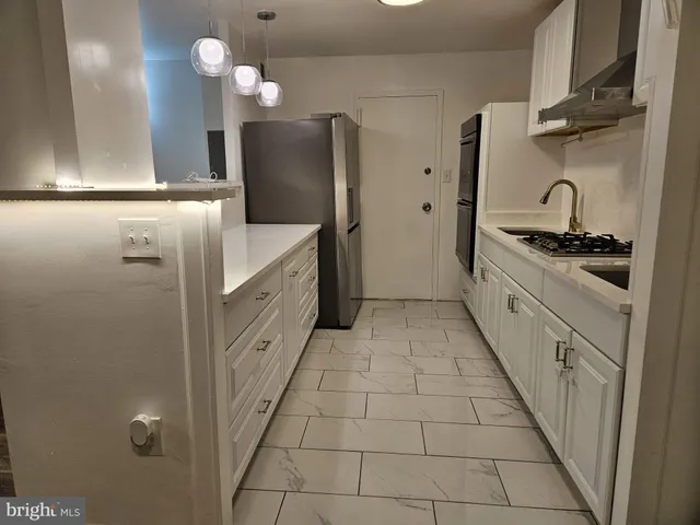 a kitchen with cabinets and stainless steel appliances