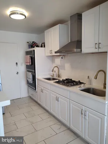 a kitchen with stainless steel appliances granite countertop a sink and cabinets