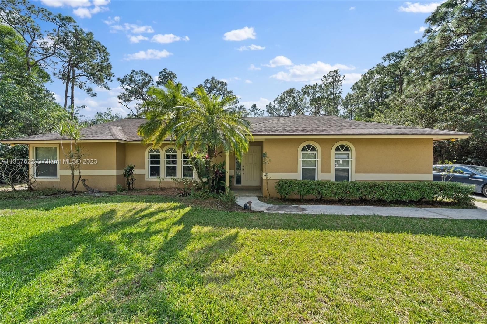 12906 154th Road North Jupiter, FL 33478 - Photo 1 of 43 a view of a house with backyard and sitting area