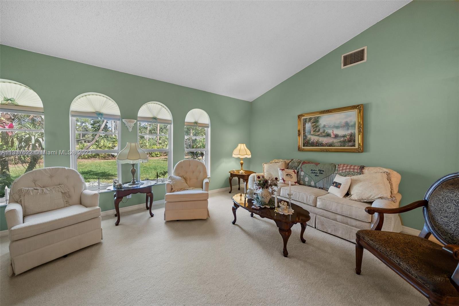 12906 154th Road North Jupiter, FL 33478 - Photo 8 of 43 a living room with furniture and a large window