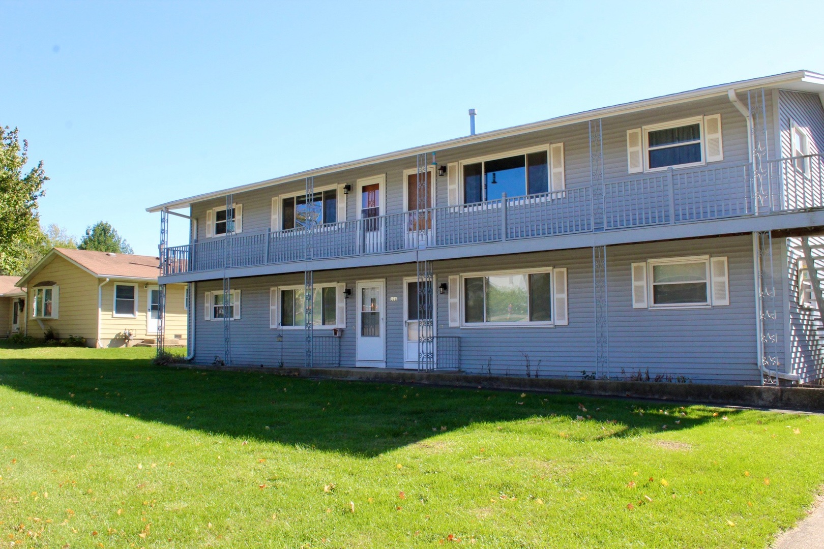 321 South Avenue, Unit C Hampshire, IL 60140 - Photo 1 of 15 a brick building with a yard in front of it