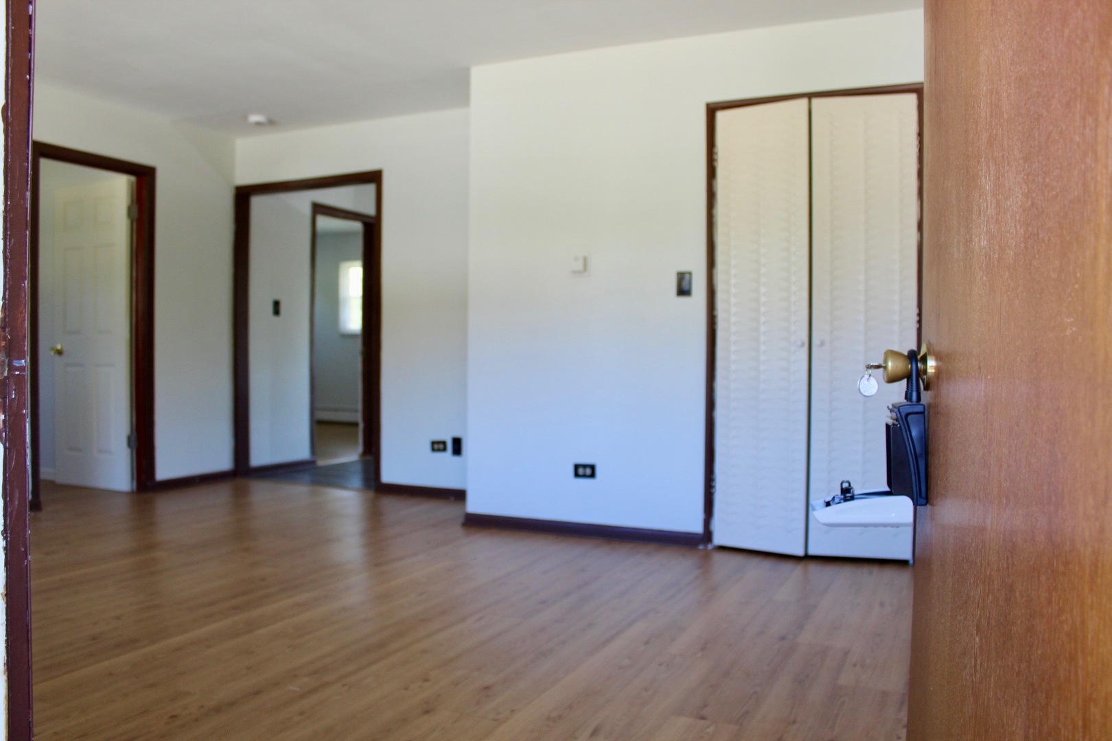 321 South Avenue, Unit C Hampshire, IL 60140 - Photo 3 of 15 a view of an empty room with wooden floor and closet area