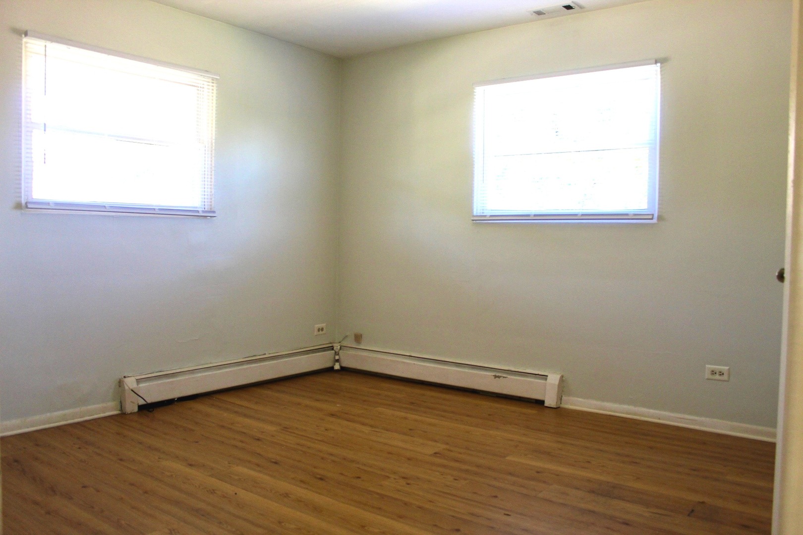 321 South Avenue, Unit C Hampshire, IL 60140 - Photo 10 of 15 an empty room with wooden floor and windows