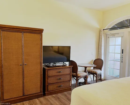 a large bed sitting in a bedroom next to a lamp