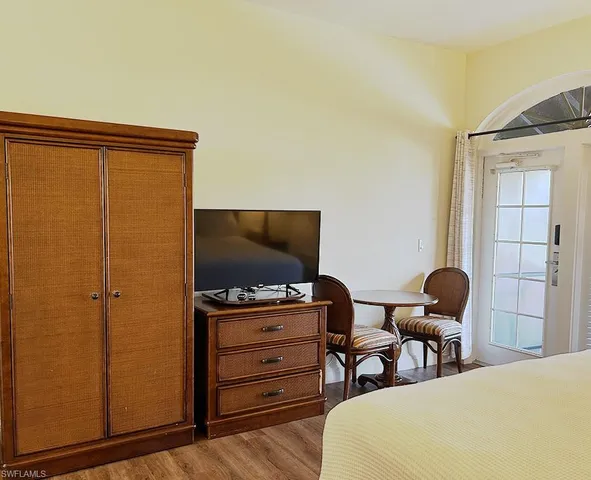 a large bed sitting in a bedroom next to a lamp