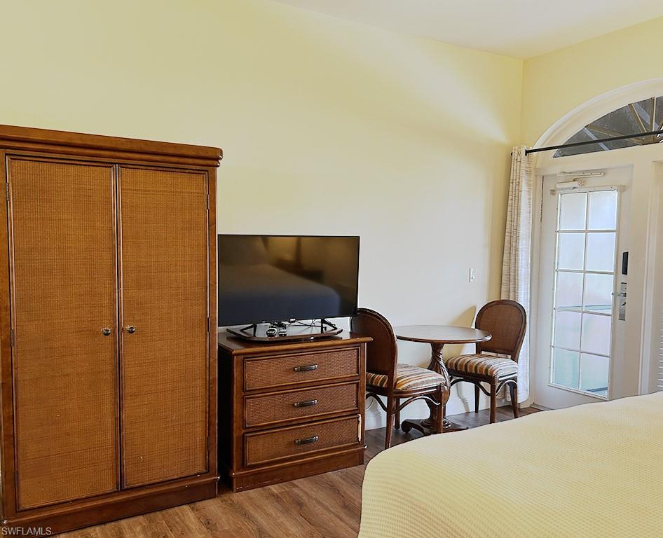 25000 Tamiami Trail East, Unit D154 Naples, FL 34114 - Photo 11 of 14 a bedroom with a bed and chair