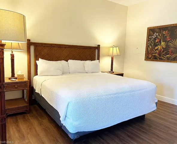 a bedroom with a bed and dresser