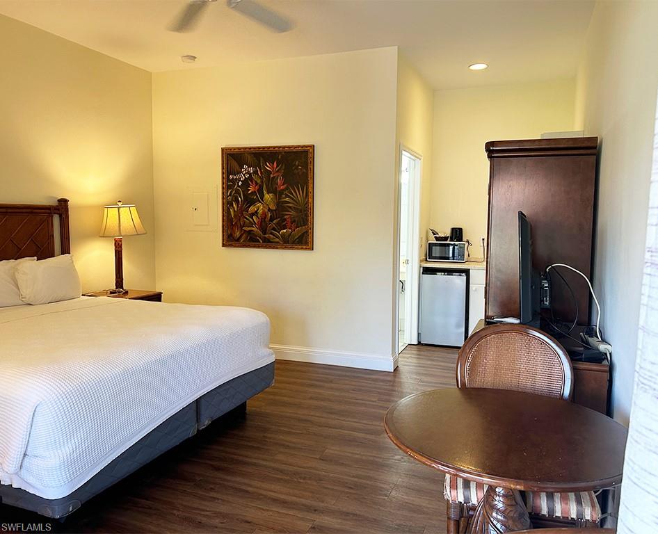 25000 Tamiami Trail East, Unit D154 Naples, FL 34114 - Photo 13 of 14 a bedroom with a bed and dresser