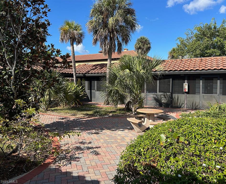 25000 Tamiami Trail East, Unit D154 Naples, FL 34114 - Photo 6 of 14 a front view of a house with garden