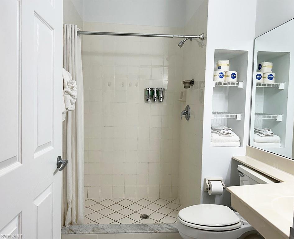 25000 Tamiami Trail East, Unit D154 Naples, FL 34114 - Photo 8 of 14 a bathroom with a toilet and a shower