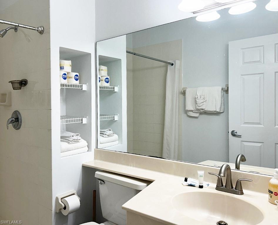 25000 Tamiami Trail East, Unit D154 Naples, FL 34114 - Photo 9 of 14 a bathroom with a sink a toilet and shower