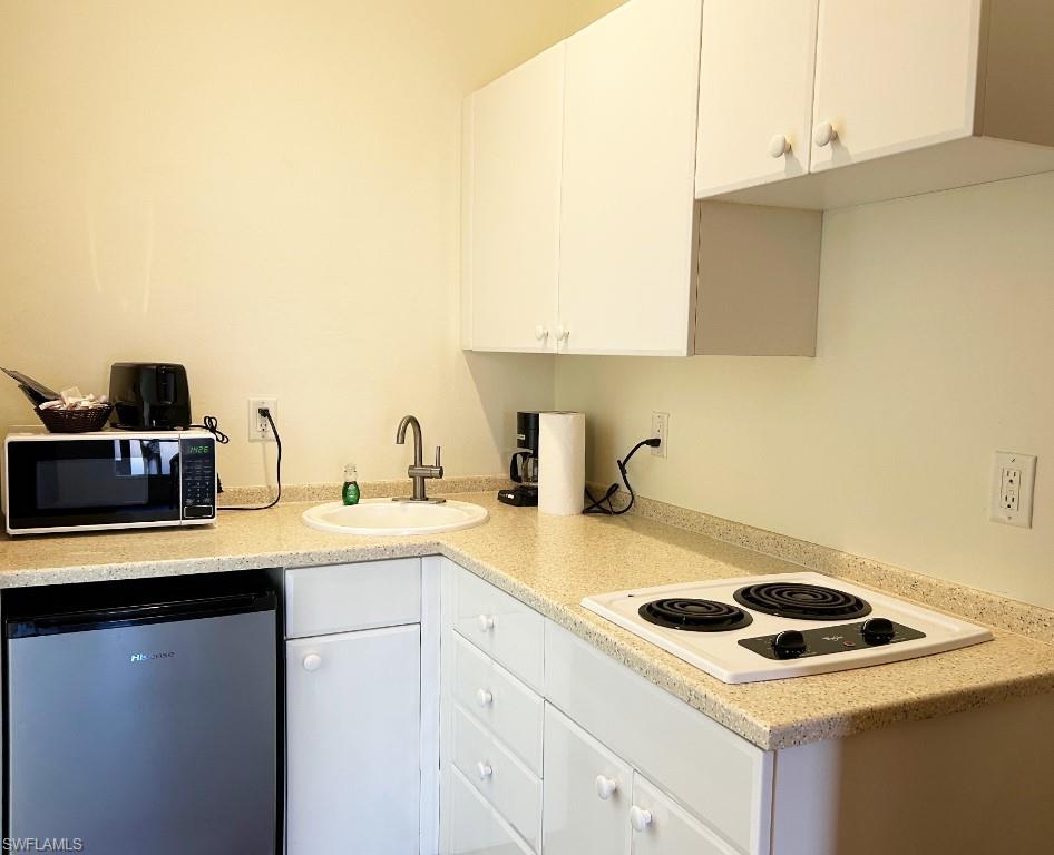 25000 Tamiami Trail East, Unit D154 Naples, FL 34114 - Photo 10 of 14 a kitchen with a sink cabinets and appliances