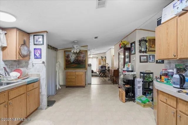 a kitchen that has a lot of cabinets a sink and a stove in it