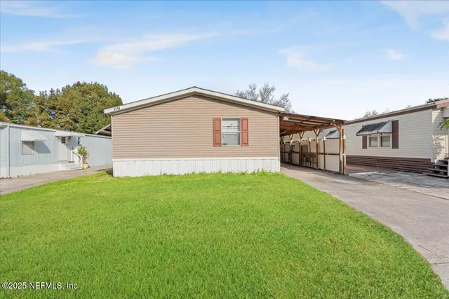 a front view of house with yard and green space