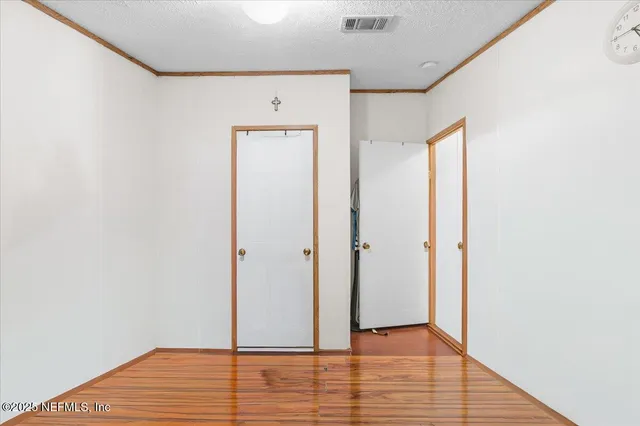 a view of hallway with wooden floor