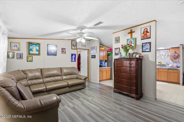 a living room with furniture and painting on the wall