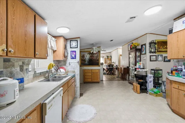 a kitchen that has a lot of cabinets a sink and a stove in it