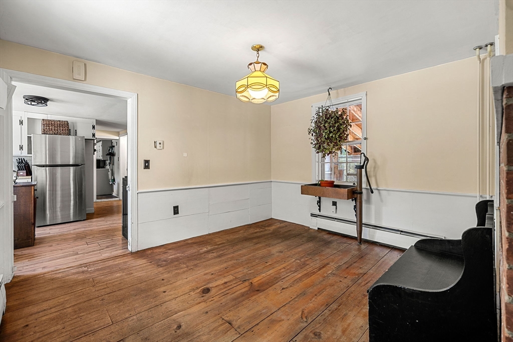 600 Main Street Ashby, MA 01431 - Photo 8 of 40 a bedroom with a bed and a chandelier