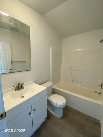a bathroom with a toilet a sink and bathtub