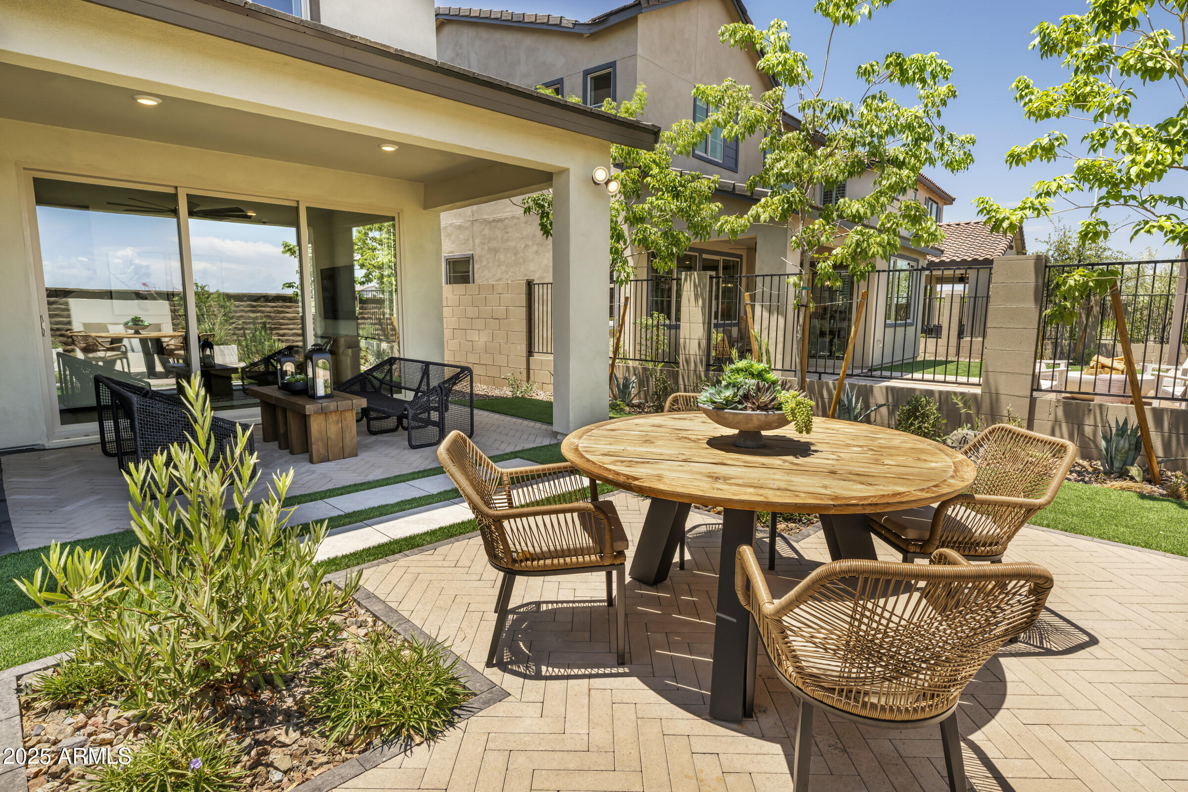1518 East Coconino Way Gilbert, AZ 85298 - Photo 11 of 14 a view of a patio with a dining table and chairs with potted plants