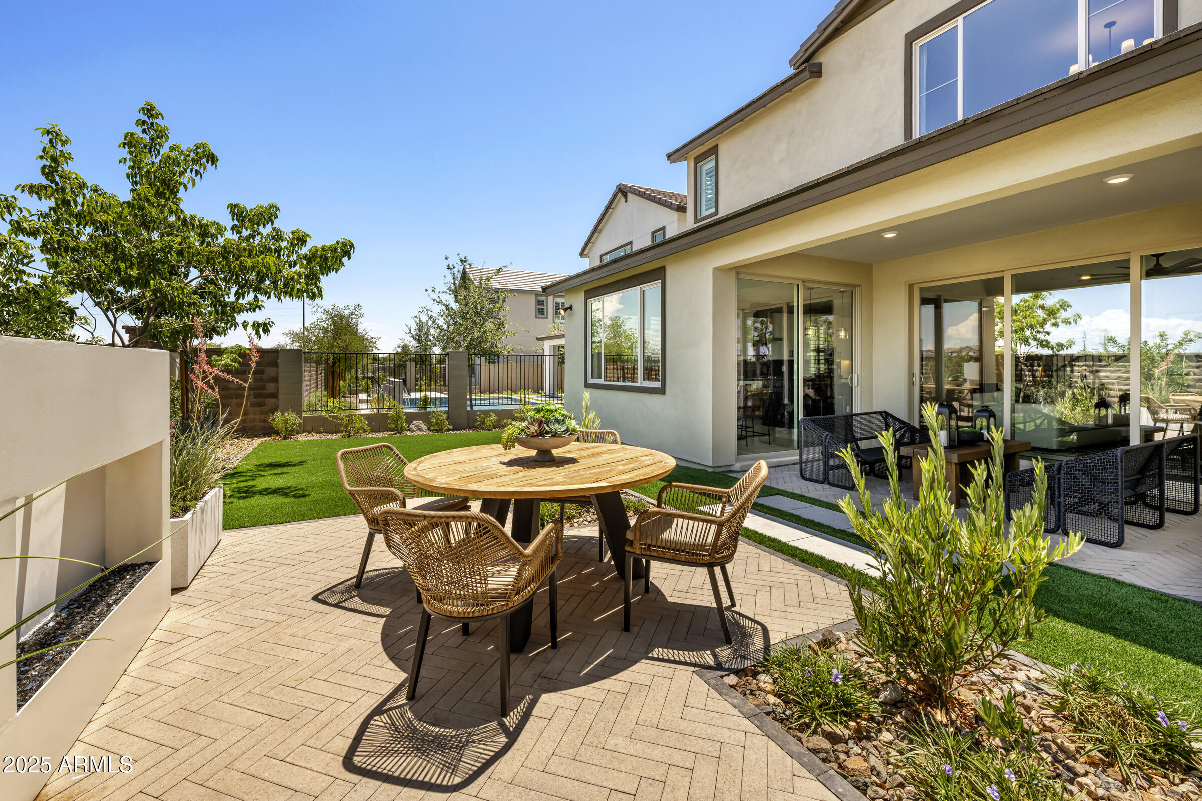 1518 East Coconino Way Gilbert, AZ 85298 - Photo 12 of 14 a view of a patio with table and chairs potted plants with wooden fence
