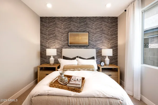 a bedroom with a bed and a window