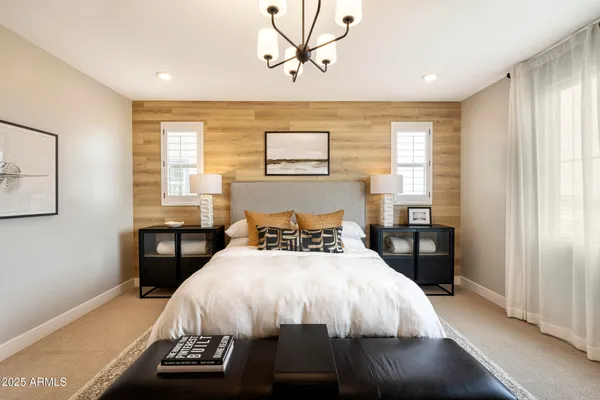 a bed sitting in a bedroom next to a window