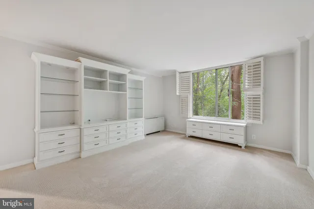 an empty room with furniture and window
