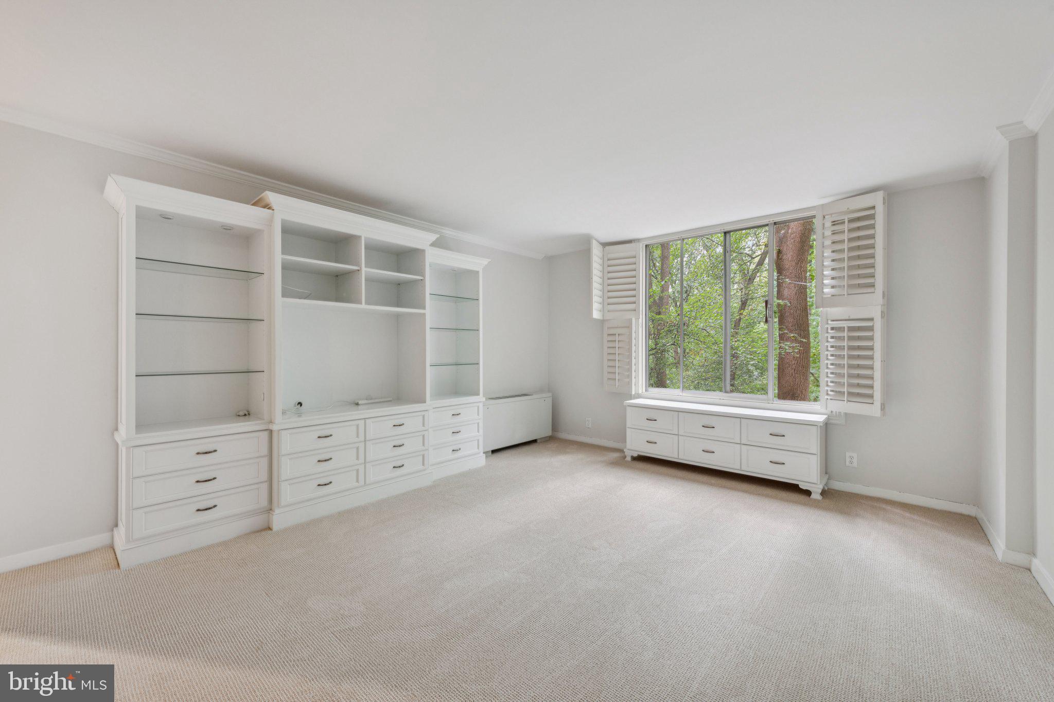 4100 Cathedral Avenue Northwest, Unit 406 Washington, DC 20016 - Photo 8 of 30 an empty room with furniture and window
